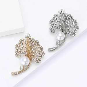 Elegant gold and silver leaf brooches with sparkling rhinestones and white pearls