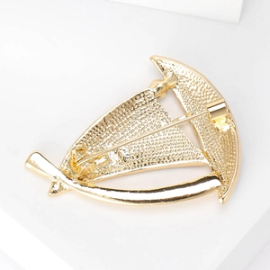 Luxurious gold enamel sailboat brooch showing back structural details and secure clasp
