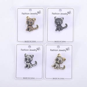 Detailed view of cat brooches with rhinestones in gold, black, silver and bronze colors