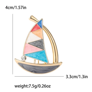 Colorful enamel sailboat brooch in gold-tone metal with sparkling rhinestone detail