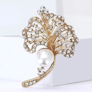 Elegant gold ginkgo leaf brooch featuring a central pearl and sparkling rhinestones