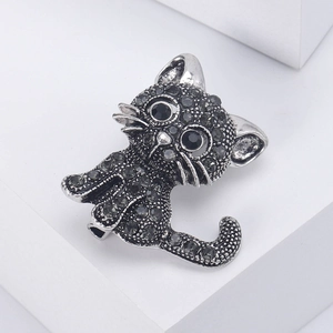 Vintage silver cat brooch with sparkling black rhinestones and gemstone eyes