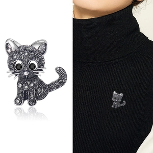 Vintage cat brooch with dark grey rhinestones on a black knit sweater for women