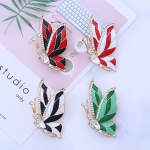 Detailed flat lay of four vintage butterfly brooches with colorful enamel and rhinestones