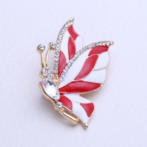 Elegant gold butterfly brooch with red and white enamel and sparkling crystal accents