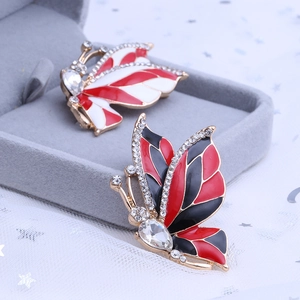 Elegant butterfly brooches in gold finish with red, white and black enamel and crystals