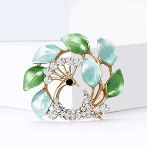 Broche couronne florale de paon élégante avec émail bleu-vert et strass étincelants