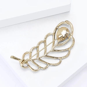 Detailed view of the hollow leaf brooch back with pin clasp and golden finish