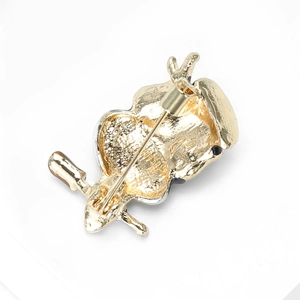 Detailed back view of the owl brooch featuring a gold-plated finish and safety pin clasp