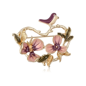 Elegant gold-plated flower and bird brooch with purple enamel and floral details