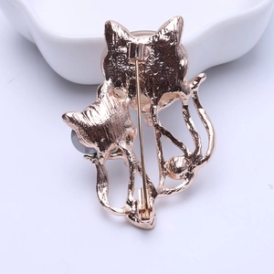 Vintage rose gold cat brooch with feline silhouettes and polished safety pin fastener