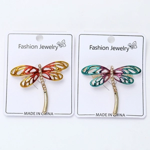 Detailed close-up of colorful enamel dragonfly brooches with rhinestone accents on wings