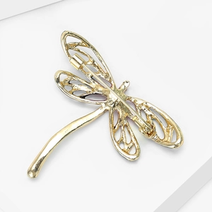 Detailed back view of enamel dragonfly brooch showing hollow wings and safety pin