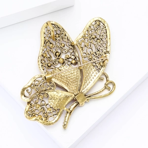 Detailed back view of vintage gold butterfly brooch showing the metal pin clasp mechanism