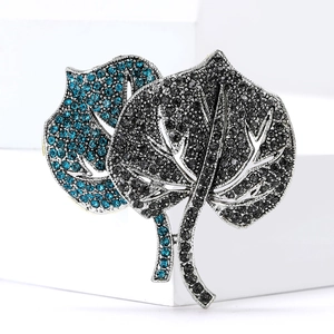 Elegant dual leaf brooch with bright blue and dark grey rhinestones on silver alloy