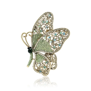 Vintage alloy butterfly brooch with emerald green rhinestones for elegant suits