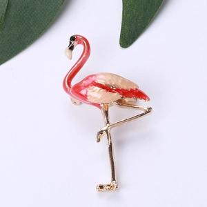 Macro detail of elegant gold alloy flamingo brooch with colorful enamel finish