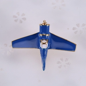 Detail of vintage airplane brooch with navy blue enamel and bright gold-tone edges