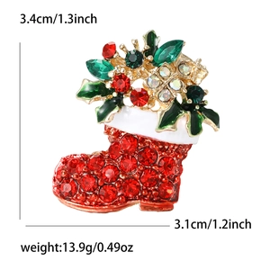 Christmas boot brooch with red rhinestones and green enamel leaves in gold finish