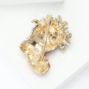 Enamel Santa shoe brooch in gold alloy with festive red and green accents on display