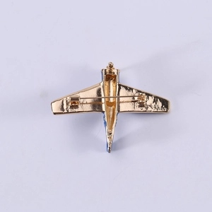 Cartoon airplane brooch in gold alloy with blue enamel and secure pin clasp on back
