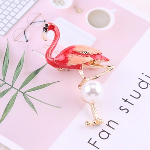 Detail of flamingo brooch with pink enamel gradient and large white pearl accent