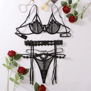 Detailed flat lay of black floral lace lingerie set with sheer mesh and embroidery