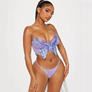 Detail of purple mesh lingerie set with intricate butterfly embroidery on the bustier