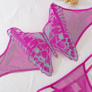Close-up of butterfly embroidery details and sheer mesh texture on purple lingerie set