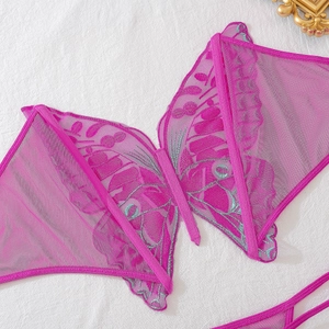 Close-up of butterfly embroidery on sheer mesh lingerie in vibrant magenta and blue