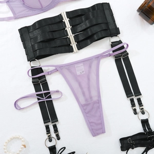 Détail du string en maille violette et du porte-jarretelles noir à crochets multiples