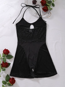 Detail of black halter mesh bodysuit featuring waist cut-outs and lace-up neck design