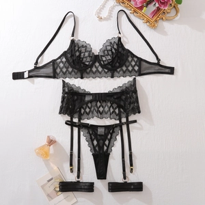 Detail of black lace lingerie set with mesh embroidery and decorative gold photo frame