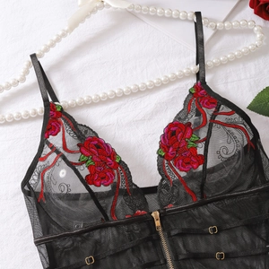 Détails de broderie florale rouge sur body en dentelle noire avec zip métallique