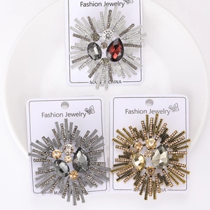 Detailed macro view of three vintage alloy brooches with crystal and rhinestone inlay