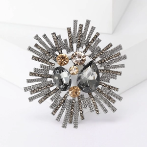 Detailed macro view of vintage starburst brooch with grey crystals on white steps