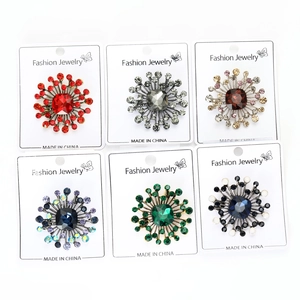 Detailed set of six vintage crystal flower brooches in various colors on display cards