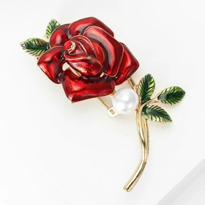 Elegant red rose brooch with green leaves and a white pearl on a gold metal base
