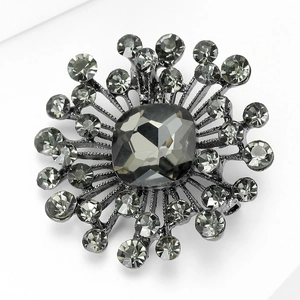 Detail view of a vintage crystal brooch with grey square stone and rhinestones