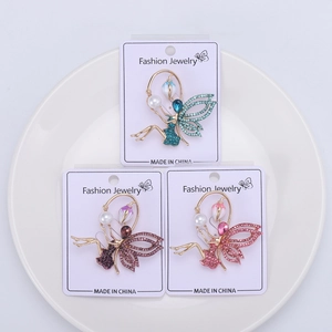 Detail view of fairy brooches with sparkling crystals and elegant pearls in three colors