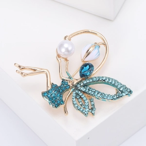 Detailed close-up of an elegant fairy brooch with blue crystals and pearls on a white stand