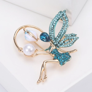 Macro shot of gold fairy brooch featuring blue crystals, pearl detail, and a tulip accent