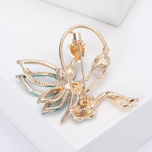 Macro shot of turquoise enamel fairy brooch wings with sparkling crystal details