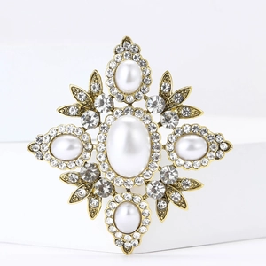 Vintage Baroque brooch featuring white faux pearls and crystals on antique gold base