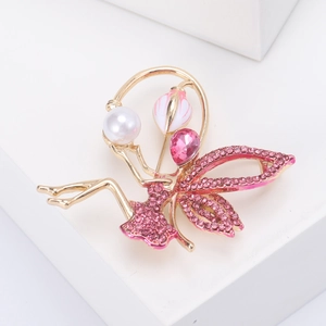 Macro detail of fairy brooch with pink rhinestones, white pearl, and tulip floral accents