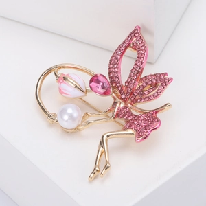 Detailed view of fairy brooch with pink rhinestones, large white pearl and tulip