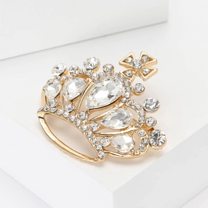 Elegant gold crown brooch with sparkling rhinestones and cross motif in royal style