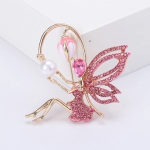 Elegant gold-tone fairy brooch with pink rhinestones and white pearl on a white background