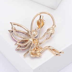 Elegant gold-tone fairy butterfly brooch with purple rhinestones and pearls from the back