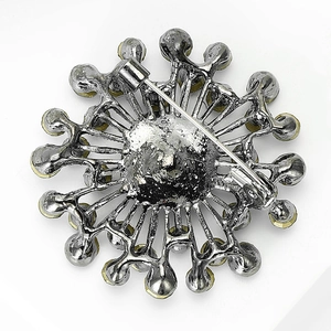 Detail of the safety pin fastener on the back of a vintage crystal glass brooch